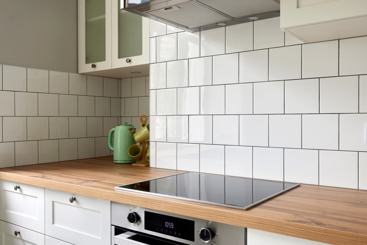 Modern Minimalist Kitchen With White Subway Tiles And Wooden Countertops For A Sleek And Elegant Look
